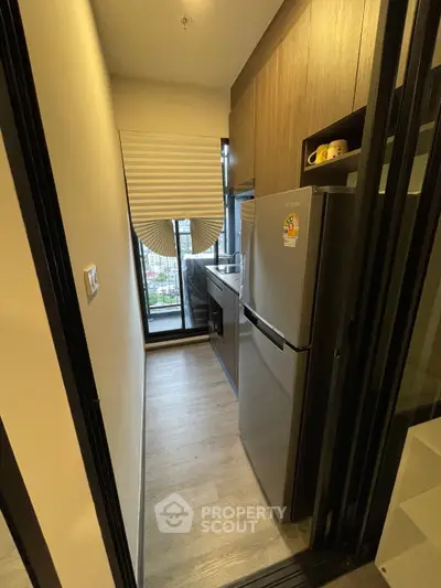 Compact kitchen with modern appliances and large window view