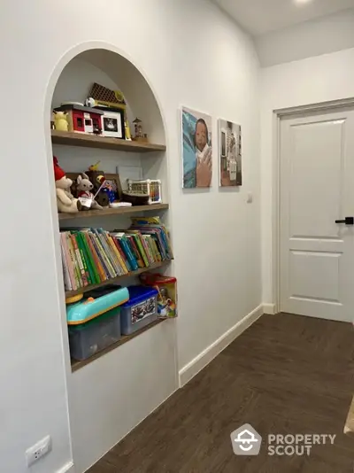 Charming hallway with built-in bookshelf and elegant decor