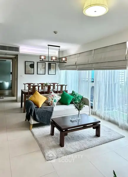 Spacious living room with modern decor and large windows offering natural light.