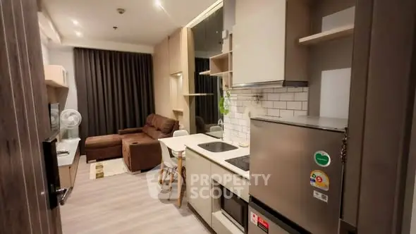 Modern open-layout kitchen and living room with stylish decor and appliances