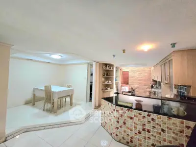 Spacious open-layout kitchen with dining area and modern decor