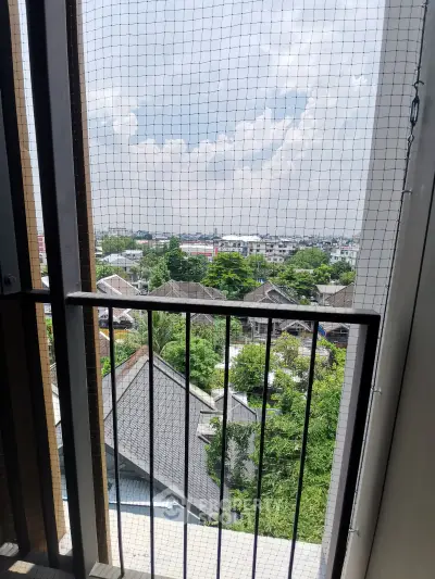 Stunning balcony view overlooking lush greenery and cityscape, perfect for relaxation and enjoying the outdoors.