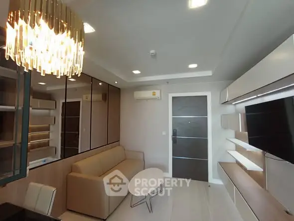 Modern living room with elegant chandelier and sleek furniture design