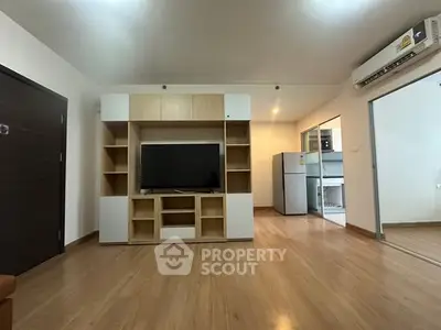 Spacious living room with modern TV unit and wooden flooring