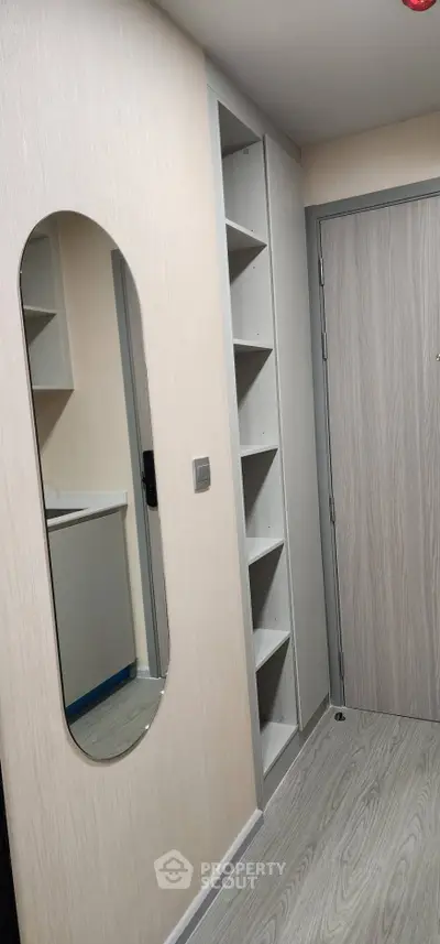 Modern apartment entrance with sleek storage and stylish mirror