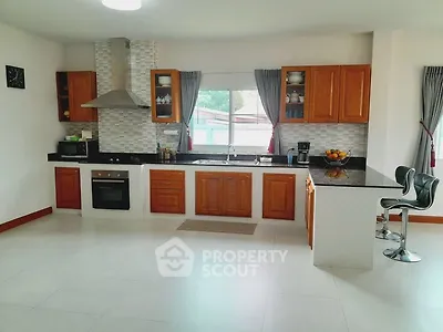 Spacious modern kitchen with wooden cabinets and open layout