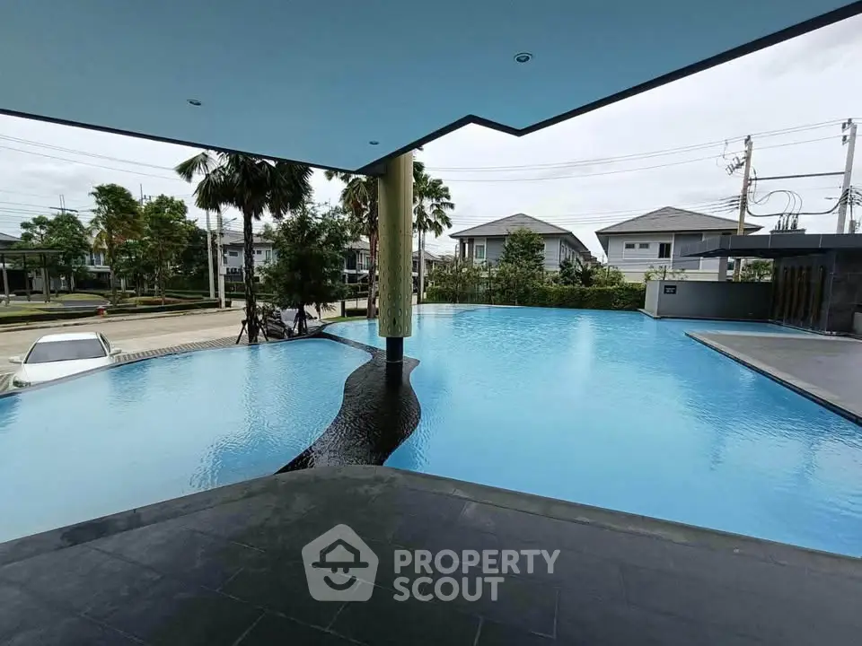 Luxurious infinity pool with modern design and serene surroundings in upscale residential area.