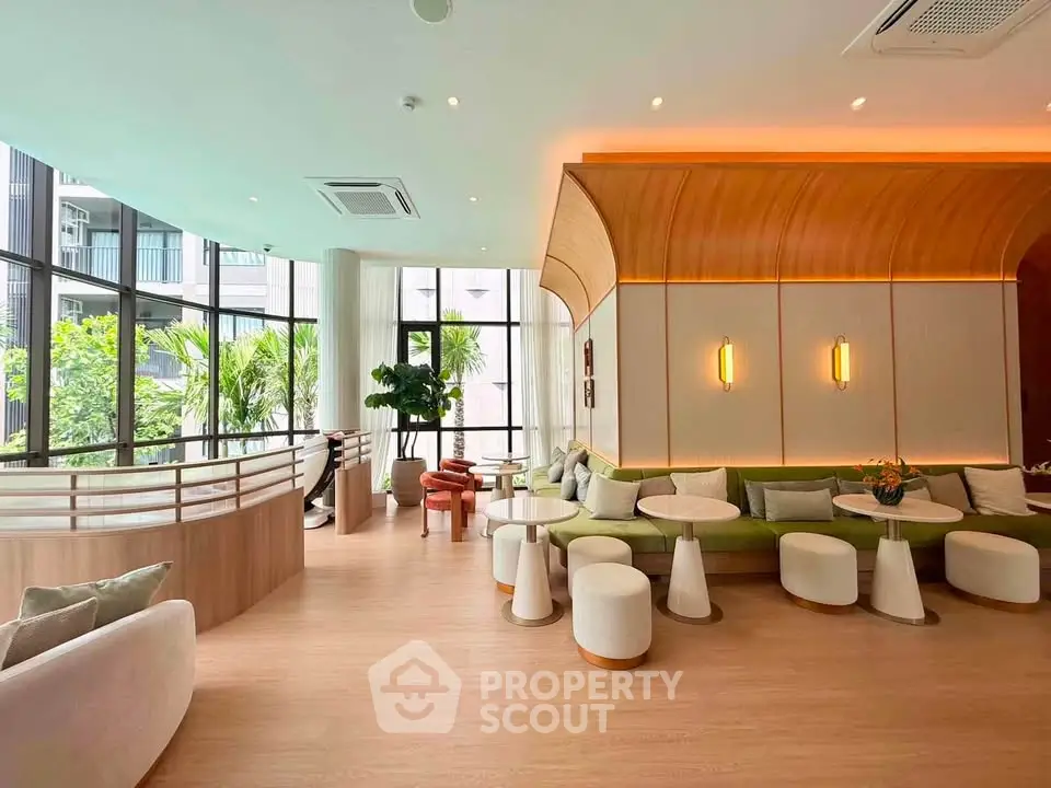 Luxurious modern living room with stylish furniture and large windows offering lush garden views.