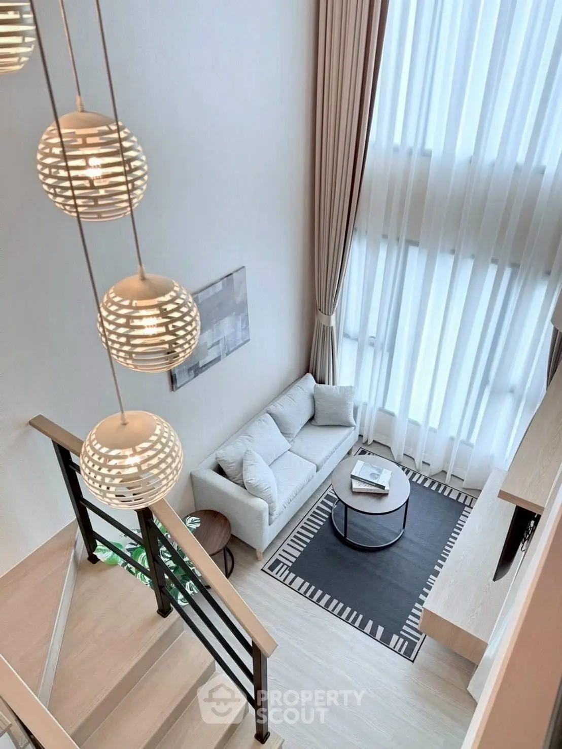 Stunning modern living room with high ceilings and elegant lighting in a luxurious apartment.