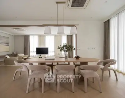 Spacious modern dining area with elegant lighting and contemporary furniture in open layout.