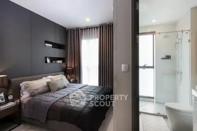 Modern bedroom with ensuite bathroom featuring sleek design and cozy ambiance.