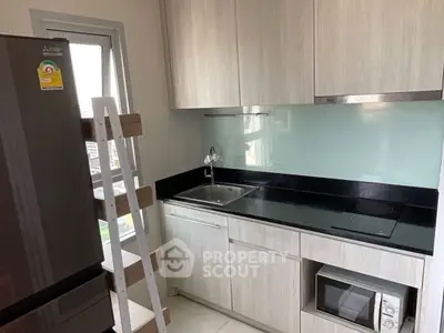 Modern kitchen with sleek cabinetry and built-in appliances