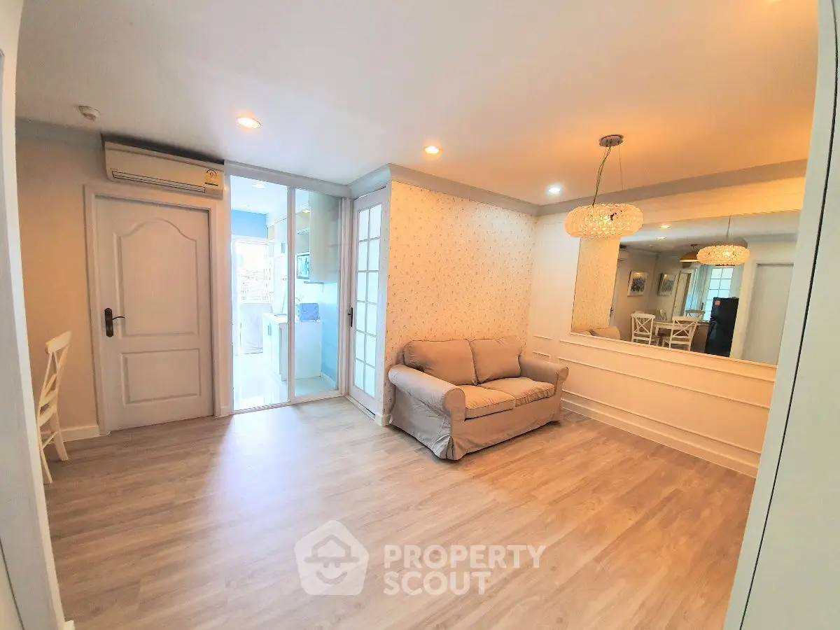 Charming living room with cozy sofa and elegant lighting in modern apartment.