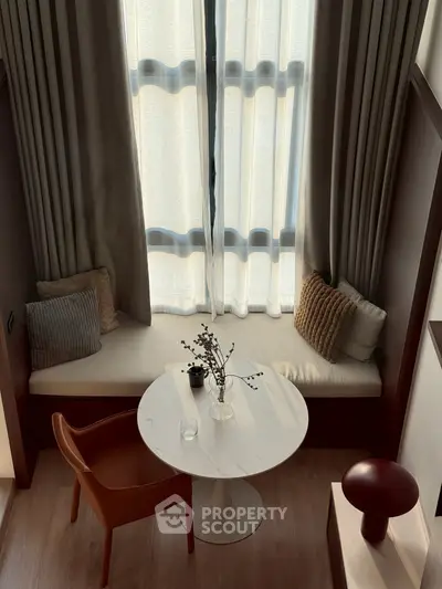 Cozy nook with elegant seating and natural light, perfect for relaxation or reading.