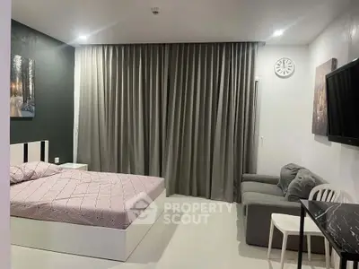 Modern bedroom with stylish decor, featuring a cozy bed, sleek furniture, and elegant curtains.