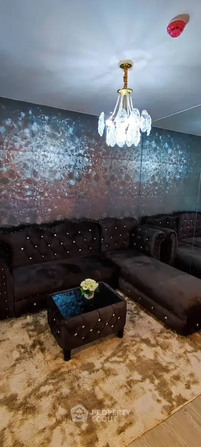 Luxurious living room with plush seating and elegant chandelier