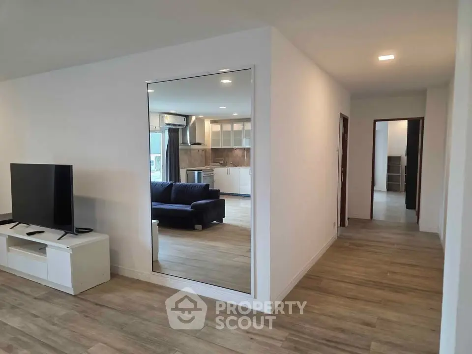 Modern open-plan living room with sleek kitchen and stylish decor