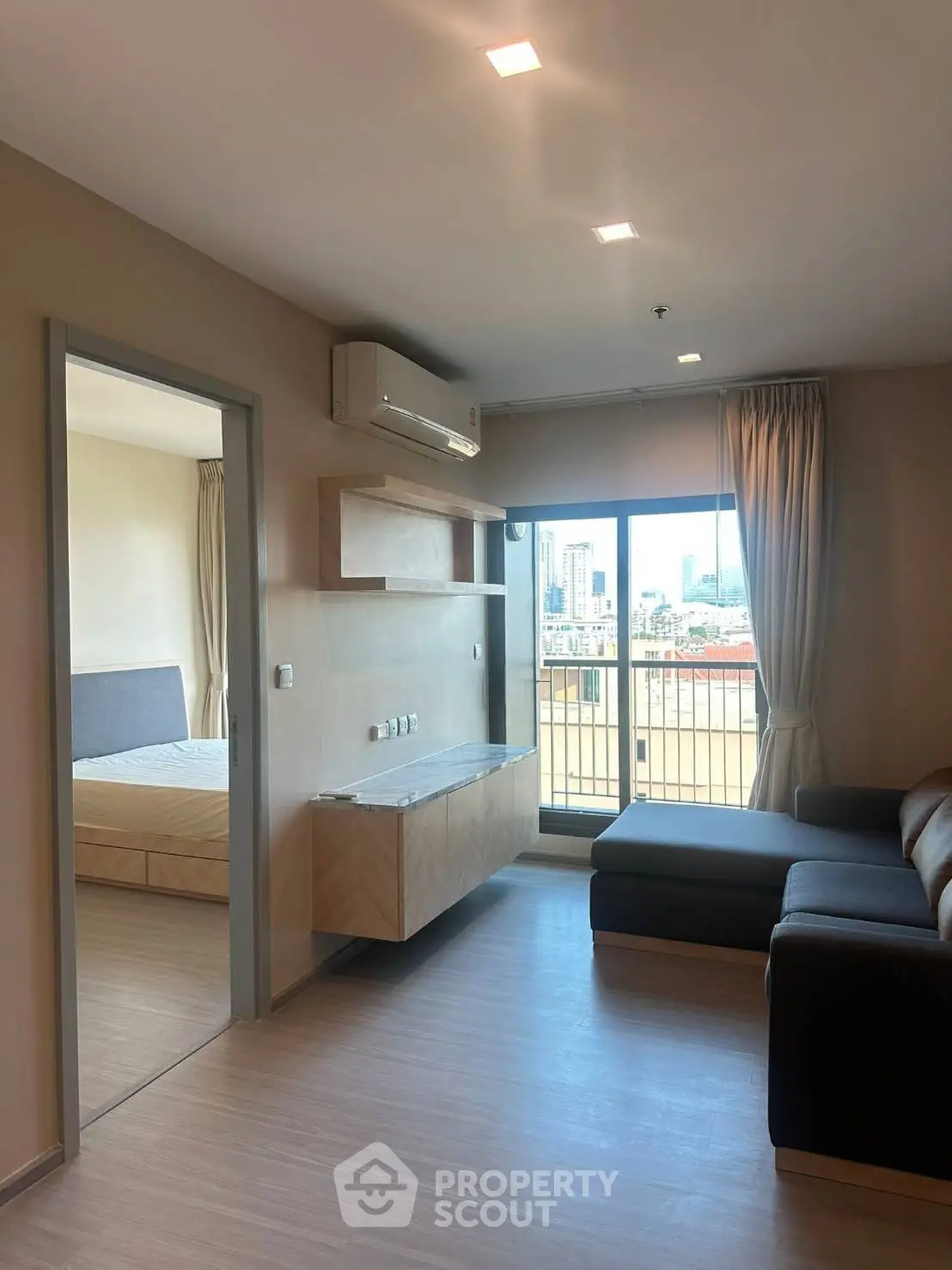 Modern apartment living room with balcony and city view