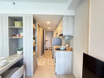 Modern kitchen with sleek cabinetry and integrated appliances in a stylish apartment.