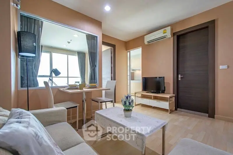 Modern living room with cozy seating and dining area, featuring natural light and stylish decor.