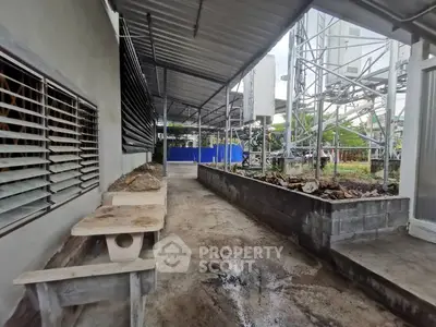 Industrial outdoor area with metal structures and concrete seating