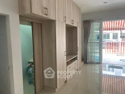Spacious living area with built-in storage and large windows for natural light.