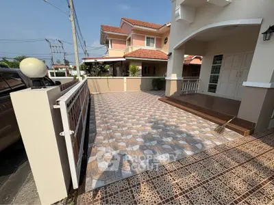 Charming suburban home with spacious tiled driveway and elegant entrance.