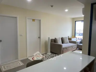 Modern living room with cozy sofa and natural light, perfect for relaxation.