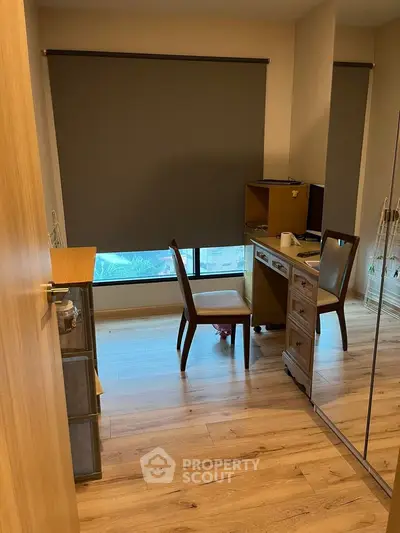 Cozy study room with wooden flooring and modern furniture, perfect for work from home setup.