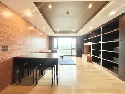 Spacious modern living room with large windows and built-in shelving