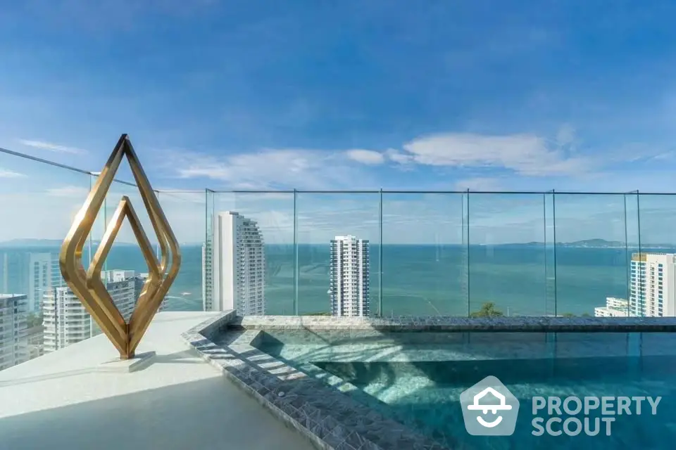 Luxurious rooftop pool with stunning ocean view and modern sculpture