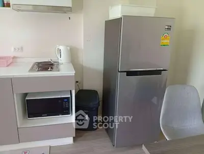 Modern kitchen with sleek appliances and stylish dining chair