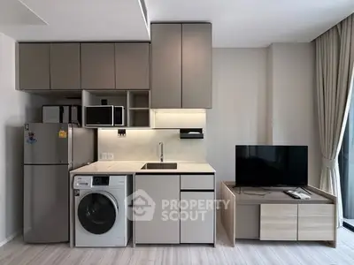 Modern compact kitchen with integrated appliances and sleek cabinetry