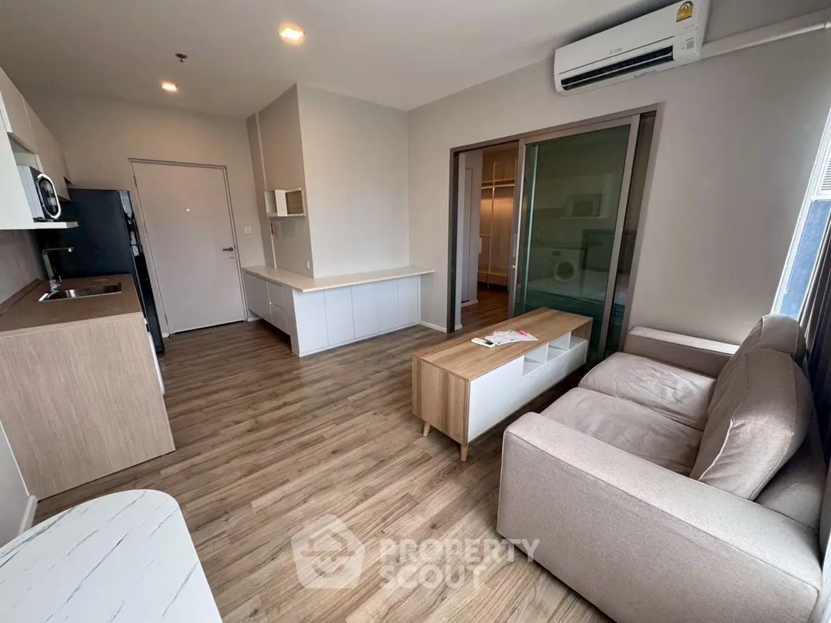 Modern living room with open layout and sleek design in a stylish apartment.