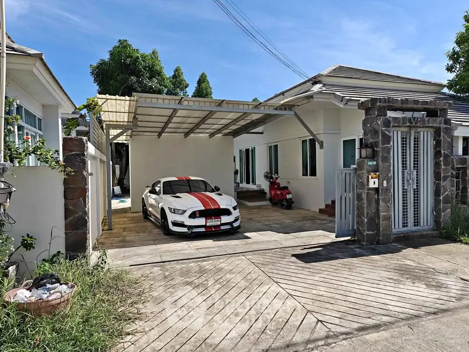 Charming single-story home with carport and modern exterior design in a serene neighborhood.