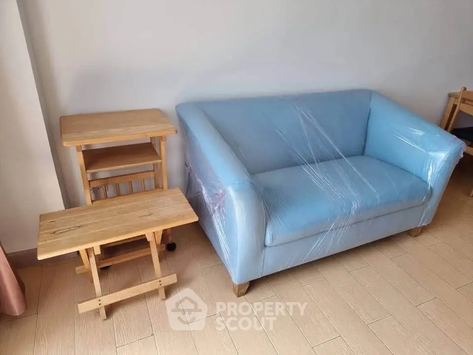 Cozy living room with blue sofa and wooden side tables