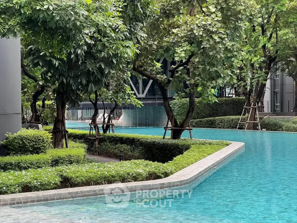 Luxurious residential pool surrounded by lush greenery and modern architecture, offering a serene oasis in the city.