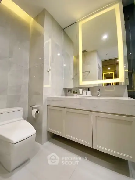 Modern bathroom with sleek design and illuminated mirror
