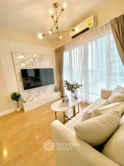 Luxurious living room with modern decor, large TV, and floor-to-ceiling windows offering city views.