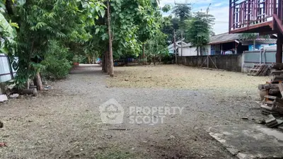 Spacious outdoor area with lush greenery and potential for development in a serene neighborhood.