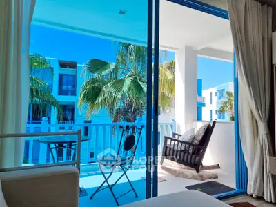 Luxurious balcony with a serene view, featuring comfortable seating and lush greenery, perfect for relaxation and enjoying the tropical ambiance.