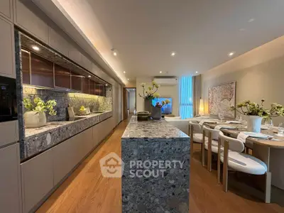 Luxurious open-plan kitchen and dining area with elegant decor and modern appliances.