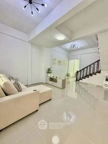 Spacious modern living room with elegant staircase and stylish lighting
