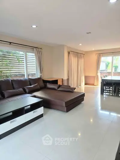 Spacious living room with modern furniture and large windows for natural light.