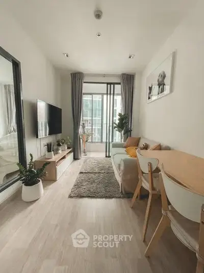 Modern living room with stylish decor and large window view, featuring cozy seating and elegant dining area.