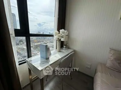 Modern study nook with city view, featuring sleek desk and elegant decor.