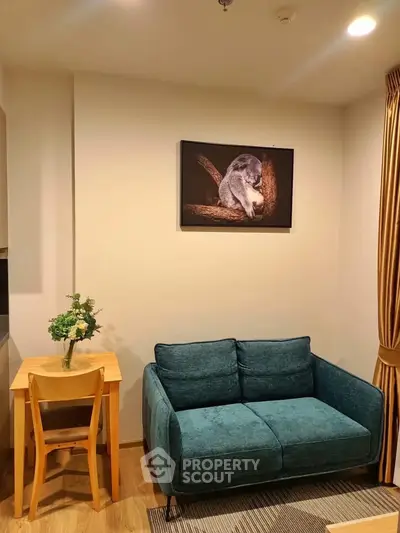 Cozy living room with teal sofa, wooden table, and elegant decor