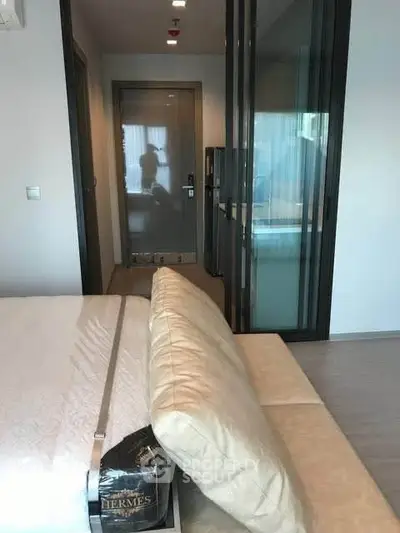 Modern bedroom with glass partitions and sleek design in a luxury apartment.
