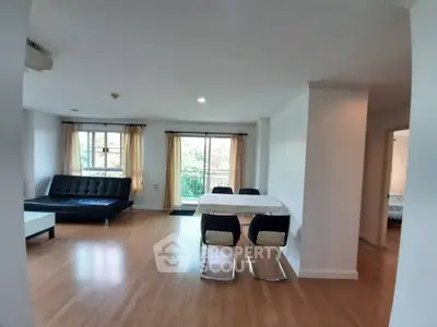 Spacious open-plan living and dining area with modern furnishings and natural light.