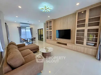 Spacious modern living room with elegant built-in cabinets and cozy seating area.